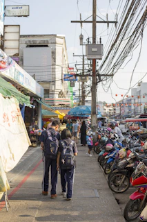 boy and girl walking beside motorcycles