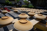 Rows of rubber products drying on racks in a factory.