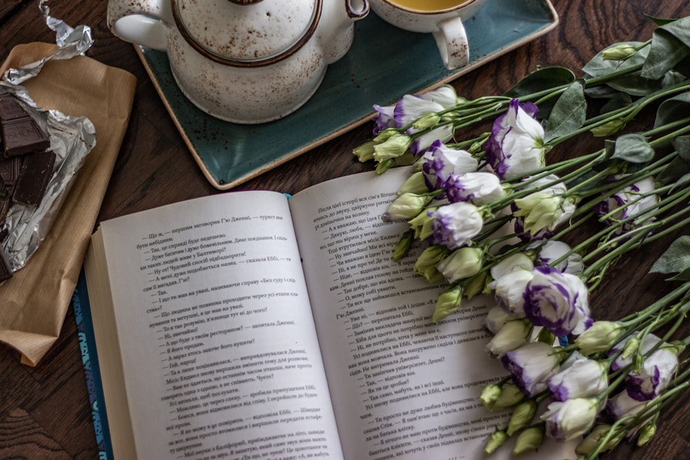 purple and white flowers on book