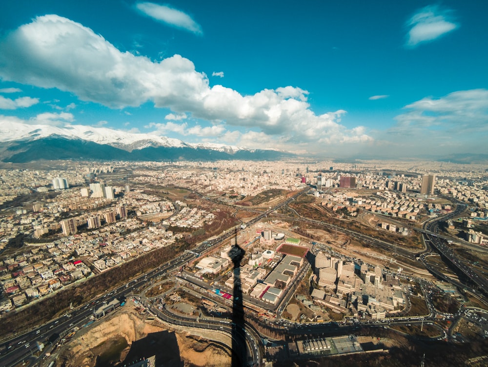 aerial photo of city buildings under cloudy sky during daytime