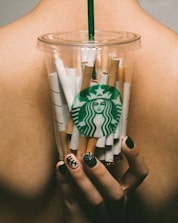 Close-up of hands holding nicotine patches and herbal teas.