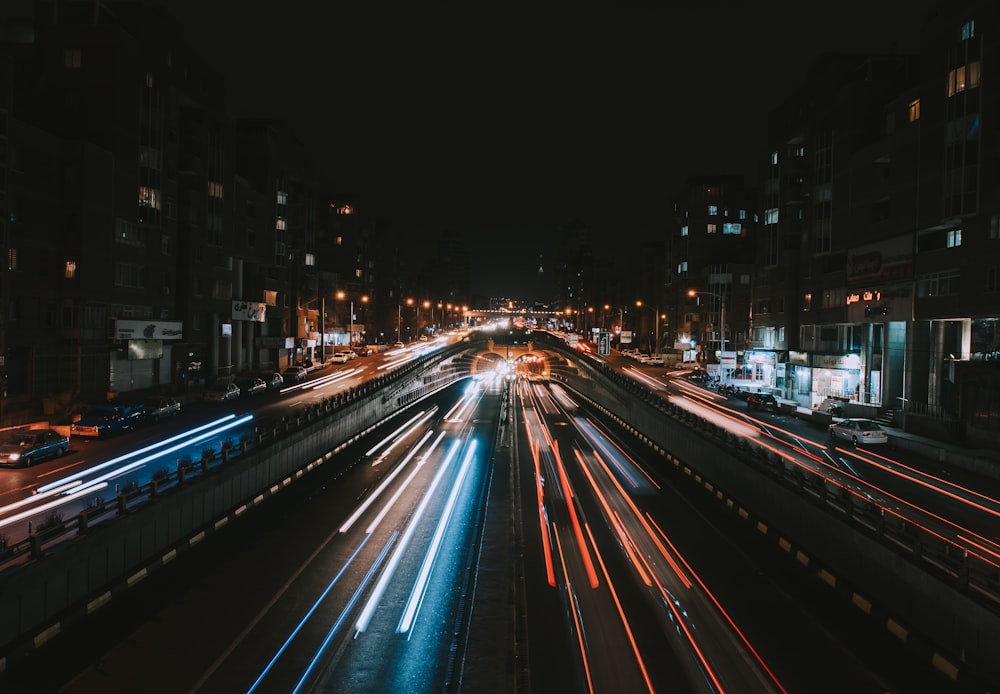 a city street filled with lots of traffic at night