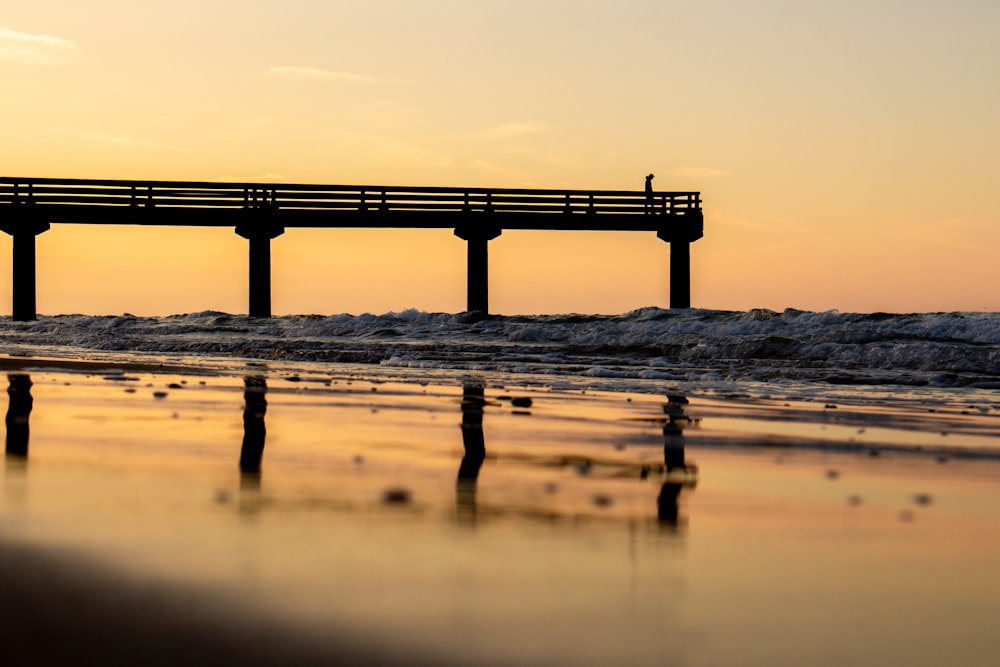 silhouette of bridge on water