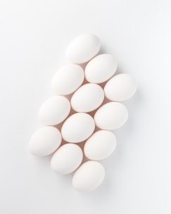 twelve white eggs on white surface