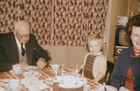 A cheerful family celebrating a birthday with an elderly member.