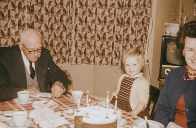 A cheerful family celebrating a birthday with an elderly member.