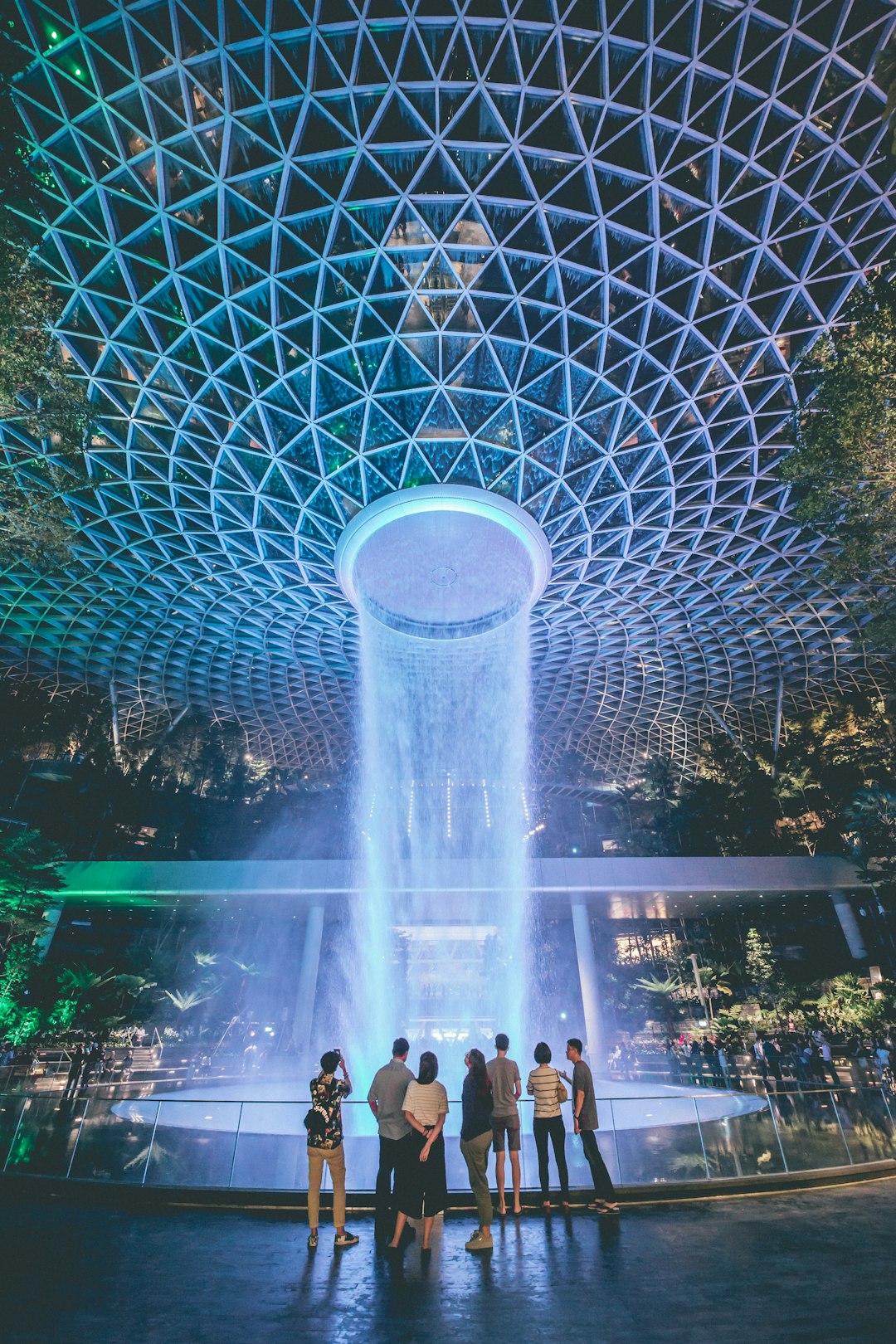 people standing in front of lighted water fountain