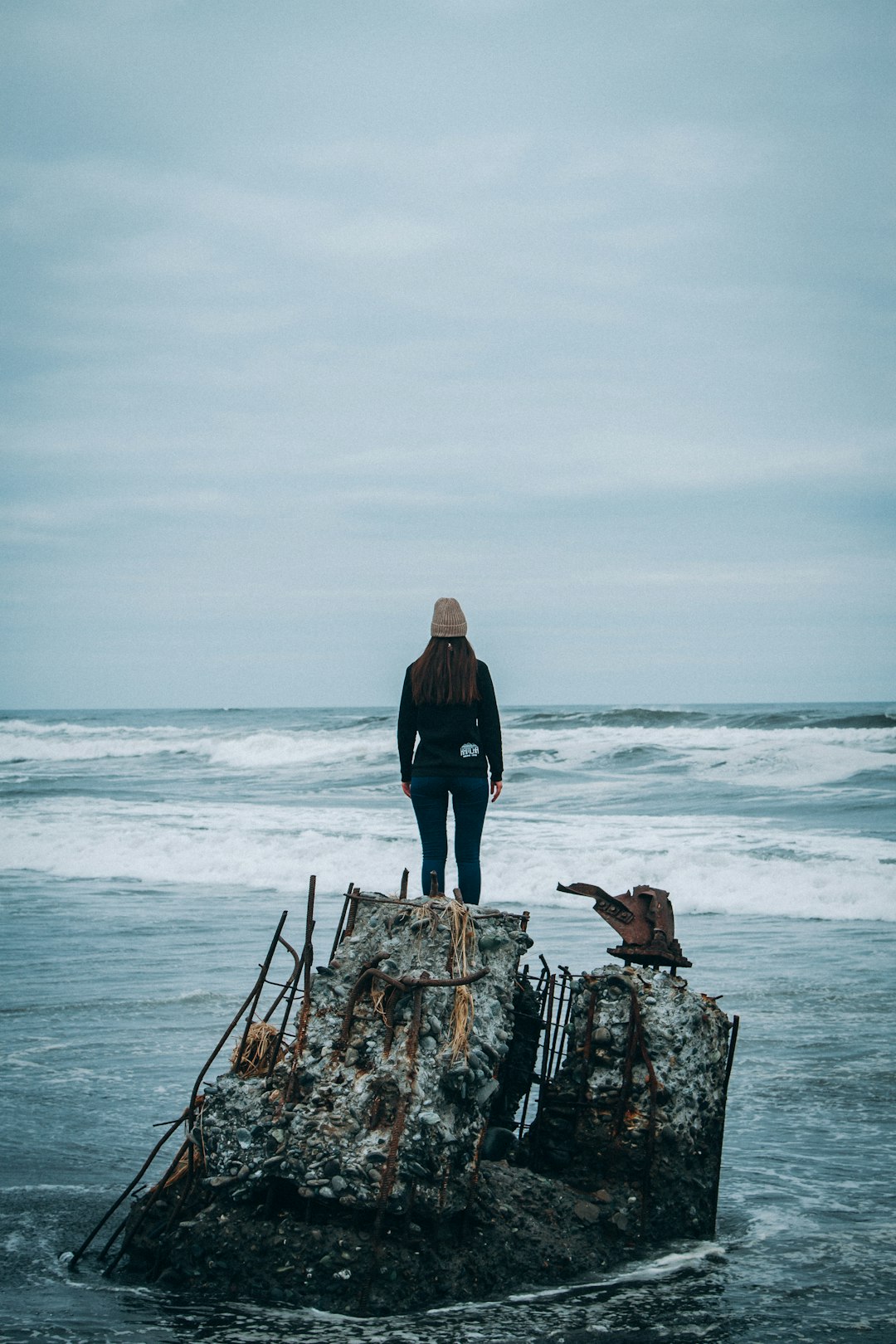 woman standing on rock front of sea