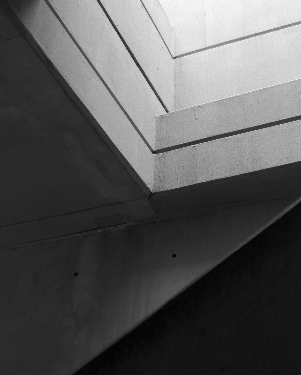 a black and white photo of a corner of a building