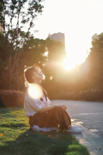 A peaceful student practicing mindfulness outdoors on campus during sunset.