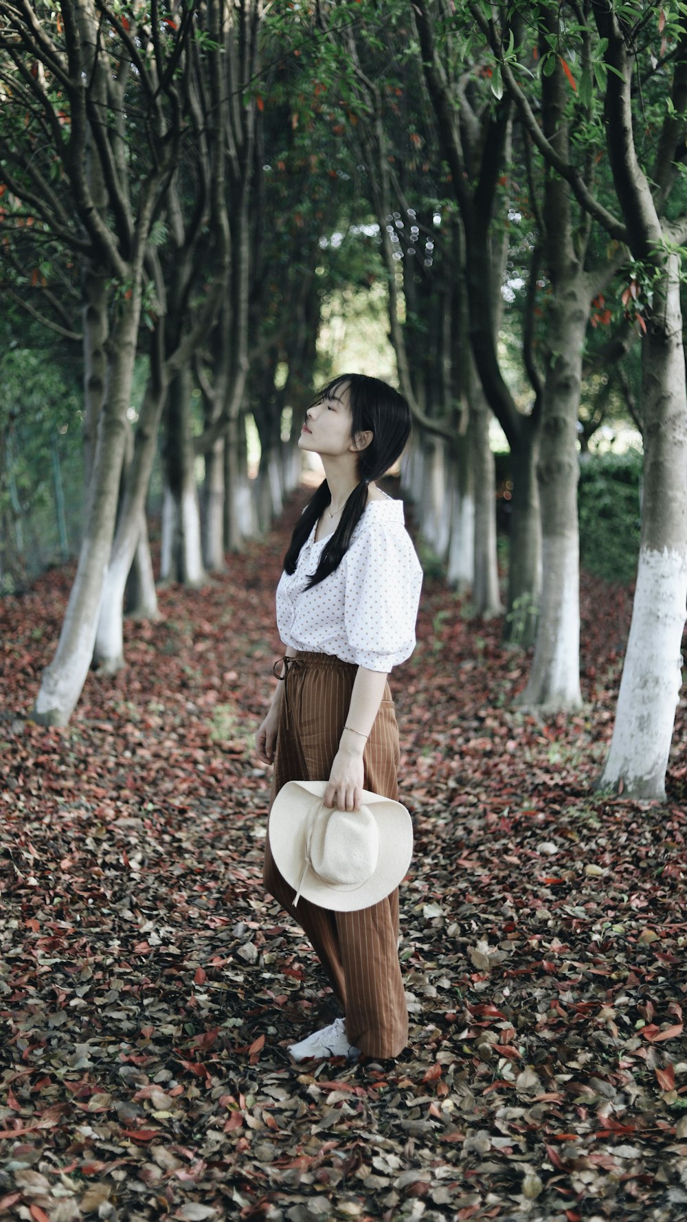 woman standing near trees