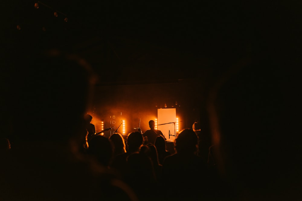 people watching men performing on stage