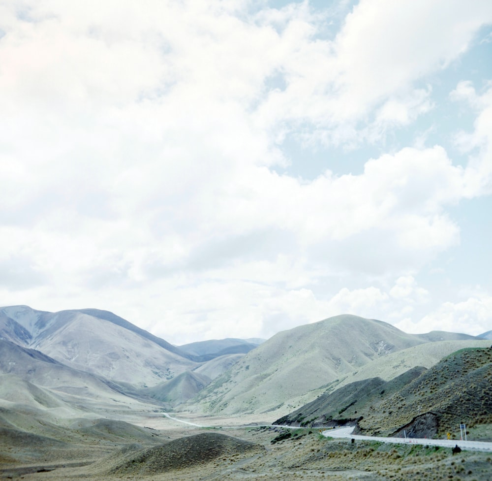 a scenic view of mountains and a road