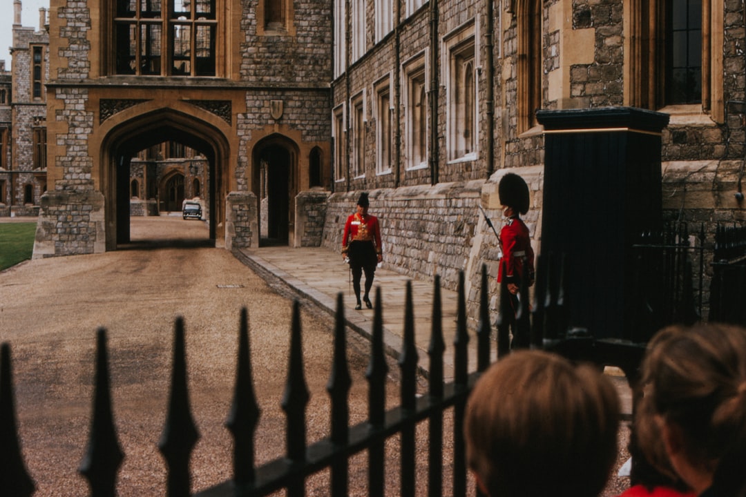 girl and boy standing beside black gate