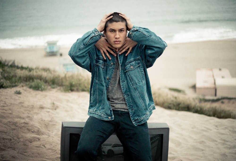 man wearing blue denim jacket