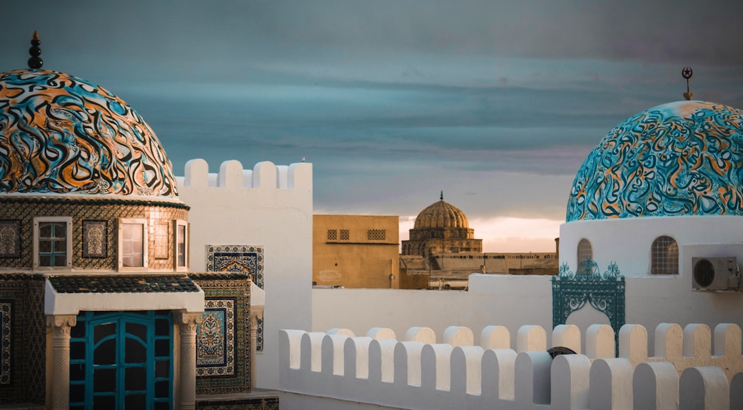 white and teal building during daytim,