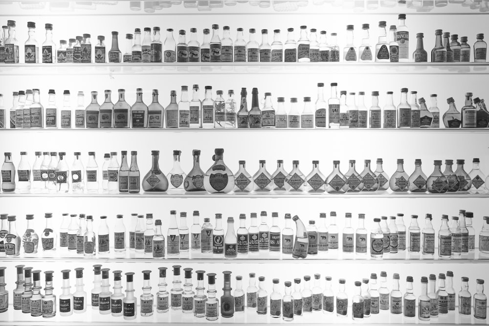 a shelf filled with lots of bottles of different shapes and sizes