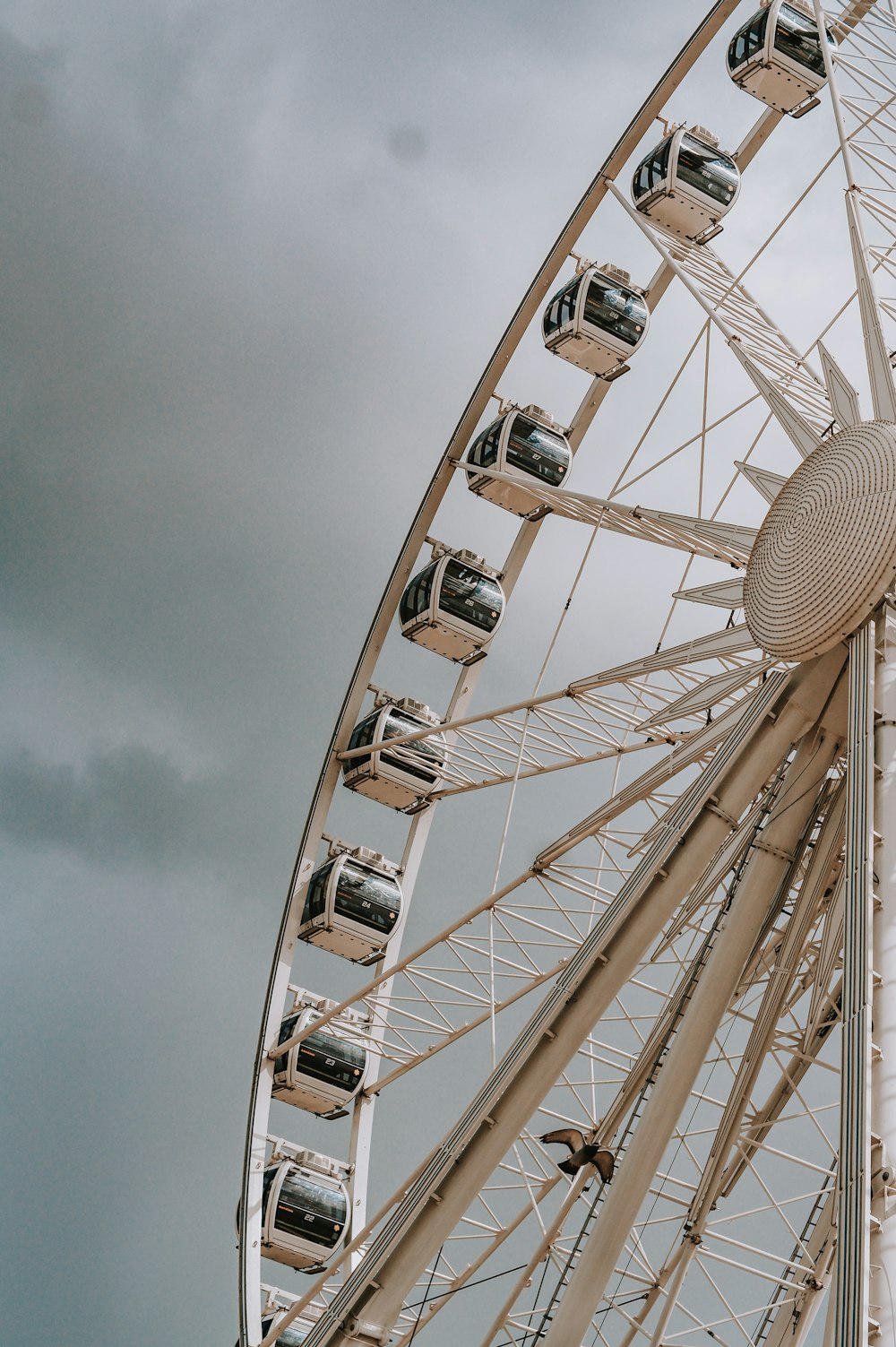 white ferris wheel under cloudy sky