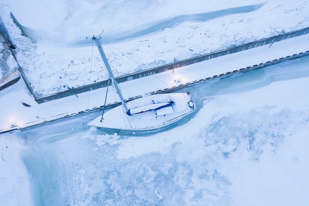 white boat surrounded by snow