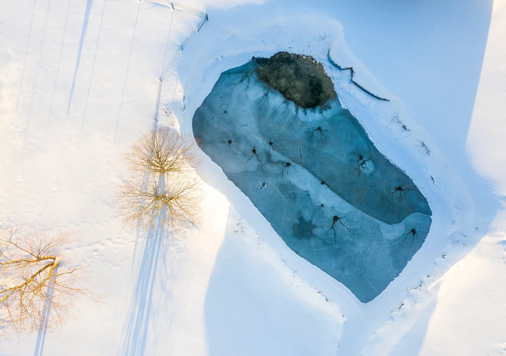 an aerial view of a frozen lake in the snow