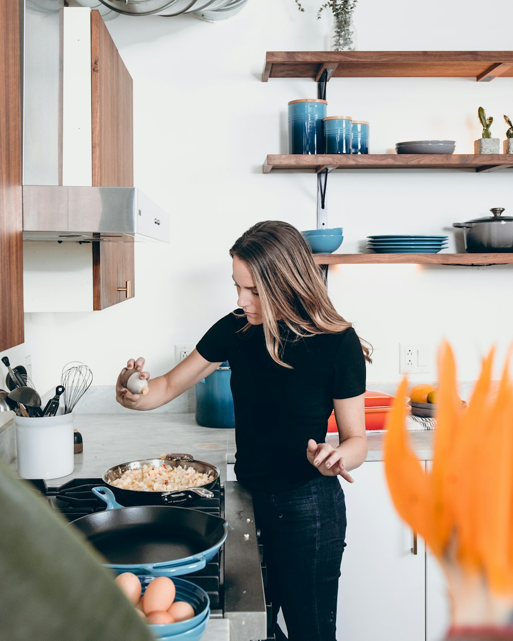 woman standing in front of freestanding range oven