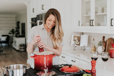 Portrait of Ruth Palma working in a modern kitchen, smiling confidently.