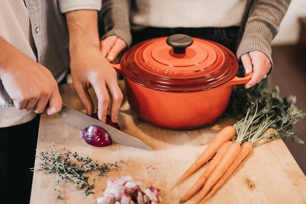 round orange pot beside vegetables