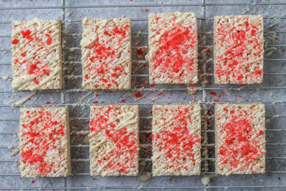 red and white cake bars cooling on a wire rack