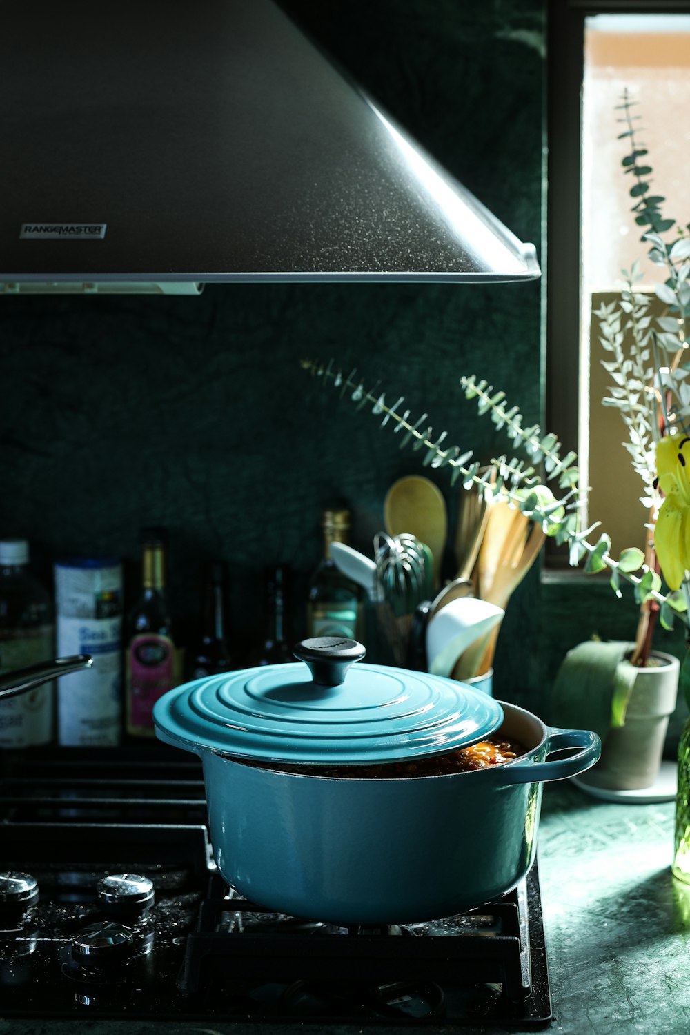 partly opened blue metal pot on stove