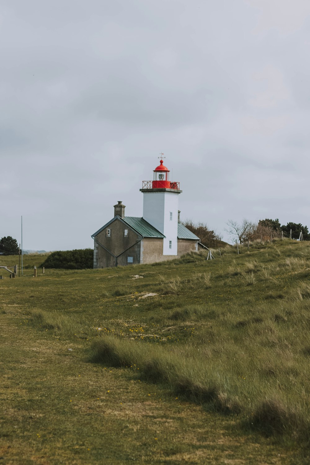 lighthouse surrounded with grass field