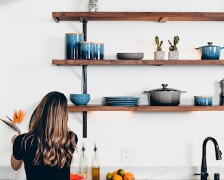 woman standing in front of kitchen sink