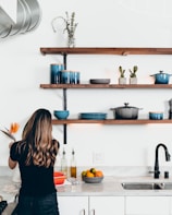 woman standing in front of kitchen sink