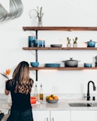 woman standing in front of kitchen sink