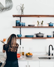 woman standing in front of kitchen sink