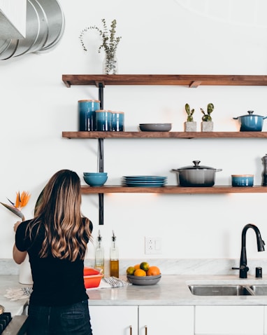 woman standing in front of kitchen sink