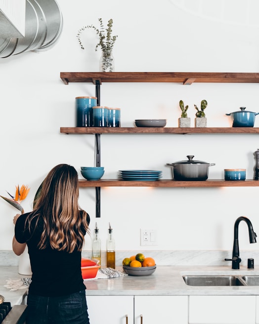 woman standing in front of kitchen sink