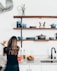 woman standing in front of kitchen sink