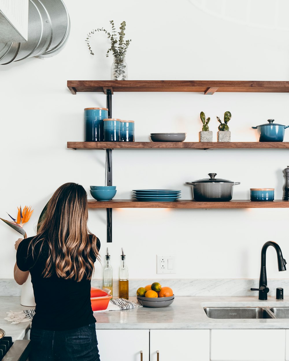 femme debout devant l’évier de la cuisine