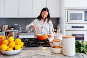 woman cooking inside kitchen room