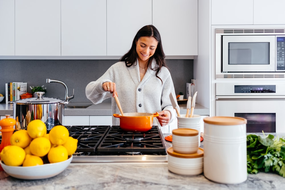 woman cooking inside kitchen room