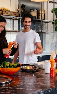 man and woman standing in front of table