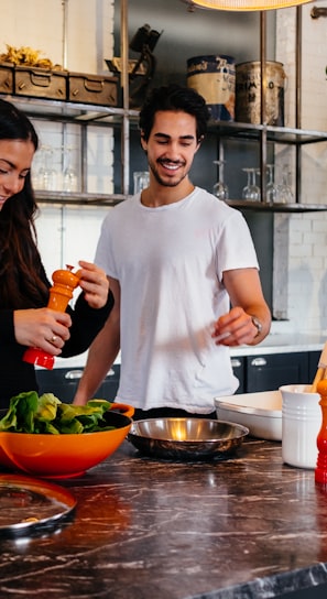 man and woman standing in front of table