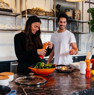 man and woman standing in front of table