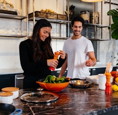 man and woman standing in front of table