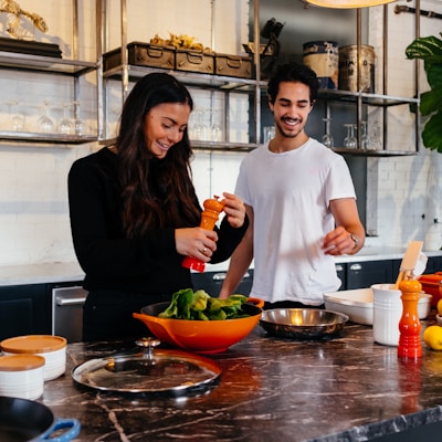 man and woman standing in front of table