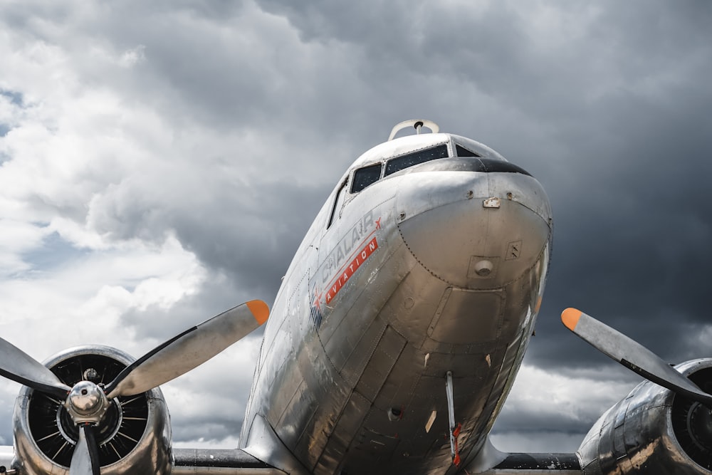 gray plane under cloudy sky