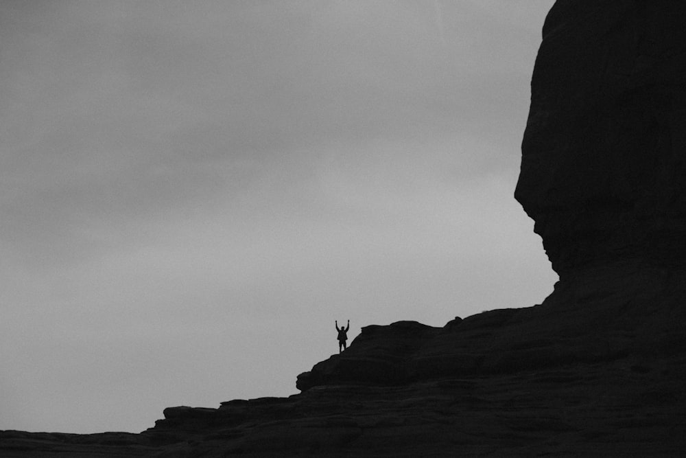 a person standing on top of a cliff