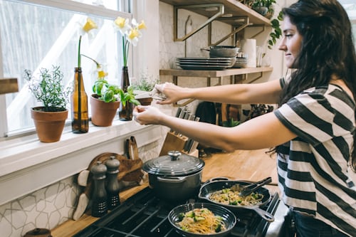 Woman in kitchen cooking