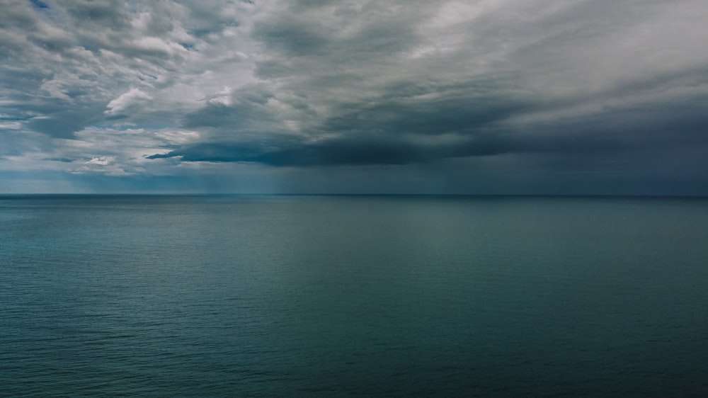 a large body of water under a cloudy sky