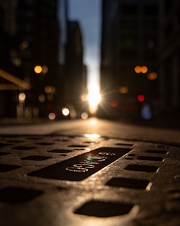grey man hole with cover at the middle of street